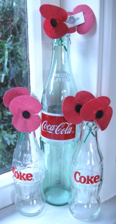 Old Coke bottle used to display ANZAC day poppies